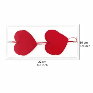 Red heart paper garland string for Valentine party wedding decoration, close-up view.