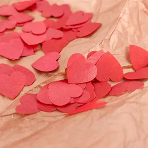 Red heart paper confetti for wedding party, romantic Valentine Day table scatter decoration.