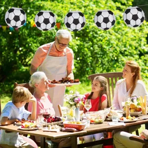 Outdoor garden party scene hanging black and white soccer paper lanterns detail view.