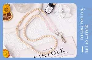 Close-up of natural wood and crystal bead phone lanyard strap detail showing fine craftsmanship.