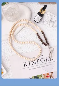 Natural wood bead and crystal phone lanyard detail close-up, stylish strap accessory.