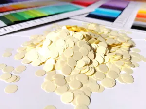 Detailed shot of yellow round paper confetti for party decoration and gift box filling 1cm