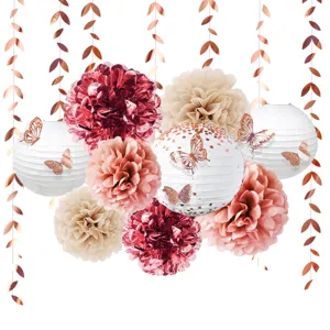 Close-up detail of hanging paper lantern and pom-pom set with rose gold butterflies for decor.