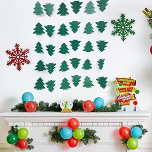 Detail view of green paper Christmas tree garland hanging on wall with festive holiday party decor.