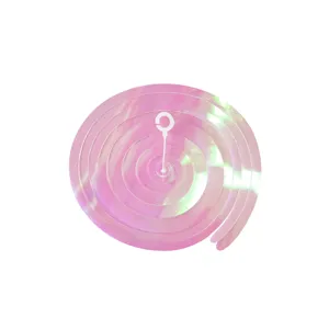Pink iridescent PVC spiral hanging decoration detail, holographic swirl party ceiling decor.