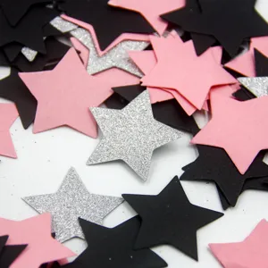 Close-up detail of glitter star confetti in pink, black and silver for wedding and party decor.