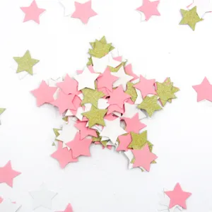 Detail view of 3cm star confetti, pink white and gold glitter pieces for wedding party decor.