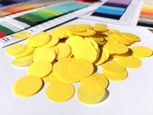 Yellow round paper confetti for party decoration, colorful stuffing dots, bulk pack for events.