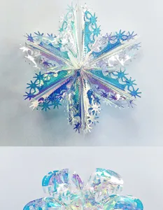 Close-up detail of holographic snowflake ornament showing laser film folding structure and shine.