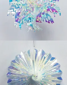 Close-up details of iridescent foil hanging ornament, holographic snowflake party decor.