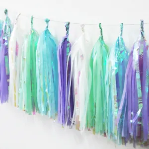 Rainbow paper tassel garland detail, holographic foil and colorful party hanging decorations.