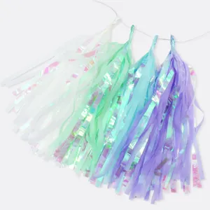 Colorful iridescent paper tassel garland detail view, ideal for wedding party decoration.