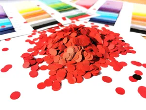 Detailed view of vibrant red round paper confetti pieces, perfect for party decorations.