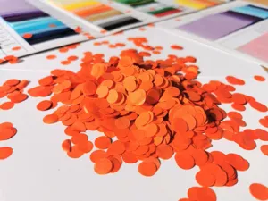 Colorful round paper confetti for party decorations, vibrant orange confetti bulk pack for events.
