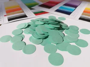 Light green round paper confetti close up for party decoration and gift box stuffing filling.