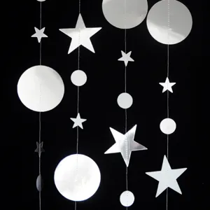 Detailed shot of hanging silver star and circle garland streamer for party decor, close-up view.