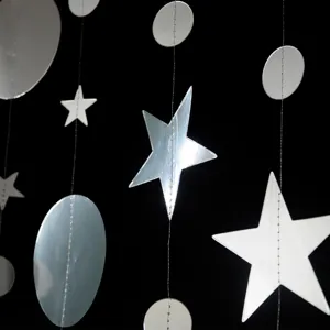 Silver star and circle garland detail shot, hanging party decoration string for events.