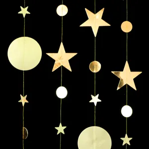 Close-up detail of metallic gold star and round circle hanging paper garland for party decor.
