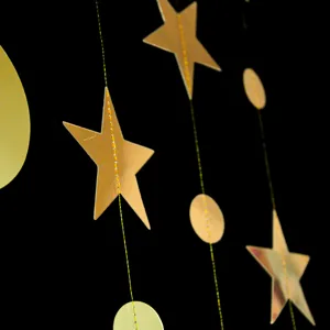Gold star and circle garland hanging detail, perfect for party and wedding decoration.