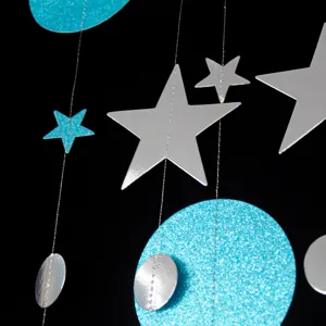 Silver stars and blue glitter circles hanging garland detail, perfect for party and festival decor.