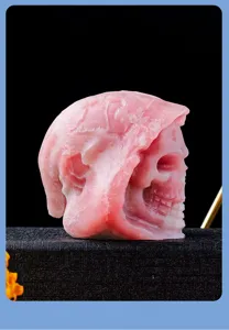 Natural pink opal crystal skull carving, gothic grim reaper statue for Halloween and home decor.