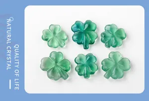Green fluorite crystal four leaf clover carved detail showing natural translucent gemstone texture.