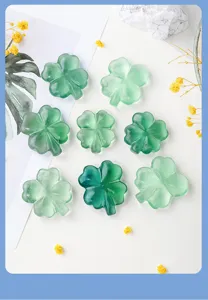 Green fluorite four leaf clover crystal carving detail, natural stone ornament layout.
