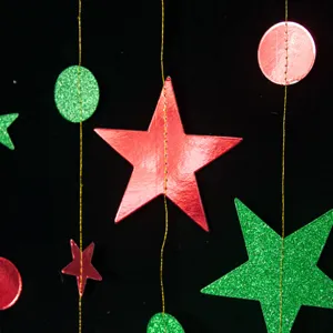Detail view of Christmas star and circle garland hanging decorations, perfect for festive party setups.