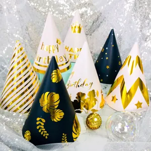 Detail shot of assorted gold foil birthday party hats with botanical and stripe patterns.
