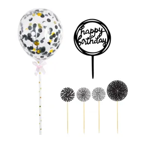 Birthday cake topper set with confetti balloon, black happy birthday sign and paper fans.