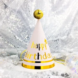 Detailed shot of a pink cone birthday hat with a gold sequin top ball for party decor.