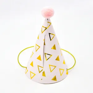 Pink cone birthday party hat with gold foil triangles and fluffy pom pom detail close up