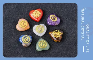 Natural crystal seven chakra heart stones set with gold symbols for yoga meditation healing.