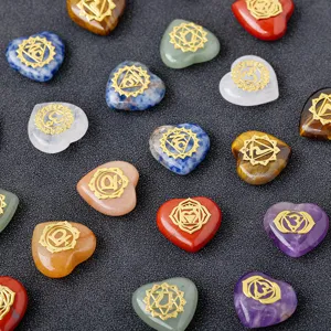 Natural crystal heart stones set with chakra symbols for yoga and reiki energy healing.