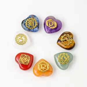 Natural crystal heart stones set with 7 chakra symbols for yoga healing and meditation decor.