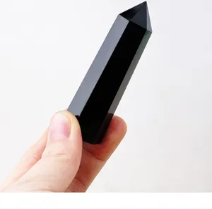 Close-up view of a polished black obsidian crystal hexagonal pillar point detail showcase.