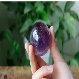 Natural Brazilian amethyst crystal sphere detail, polished crystal gemstone for home decor.