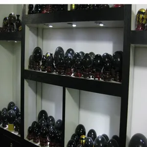 Natural obsidian sphere crystal ball with wooden base for home decor and wholesale display.