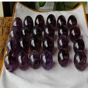 Natural amethyst crystal ball detail view, polished gemstone sphere for feng shui decor.
