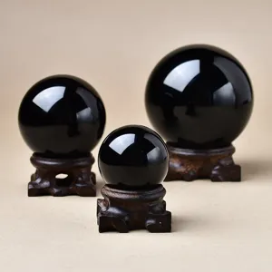 Natural obsidian crystal ball set with wooden base for feng shui decoration and gifts.