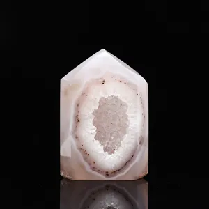 Natural polished agate geode crystal tower detail view showing sparkling quartz cluster inside.