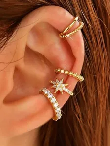 Detail view of multi-piece gold-plated brass ear cuff set featuring sparkling crystal star and bands.