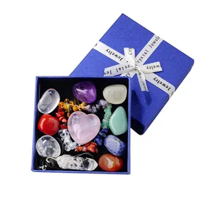 Natural crystal stones set with rose quartz heart and pendant in a blue gift box for healing.