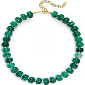 Collier de perles vertes vue détaillée, avec entretoises métalliques dorées et fermoir.