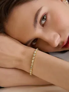 Elegantes Armband aus vergoldetem Messing mit strahlenden tropfenförmigen Zirkoniasteinen.