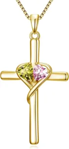 Detailed view of gold cross necklace with double heart gemstones, elegant pendant design.