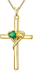 Exquisite gold cross necklace featuring dual green and yellow heart-shaped gemstone details.