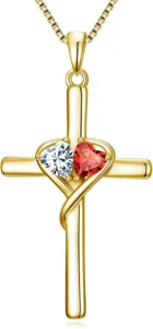 Detail shot of the gold cross pendant with dual interlocking crystal and ruby heart gemstones.