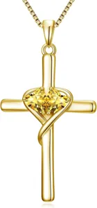 Gold cross heart pendant necklace detail, sparkling yellow gemstone jewelry for women.
