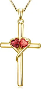 Detail view of gold cross pendant necklace featuring double red heart stones and box chain.